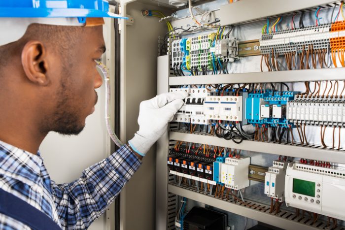 Photo Of Young African Male Technician Checking Fusebox